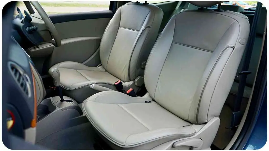 the interior of a car with two leather seats